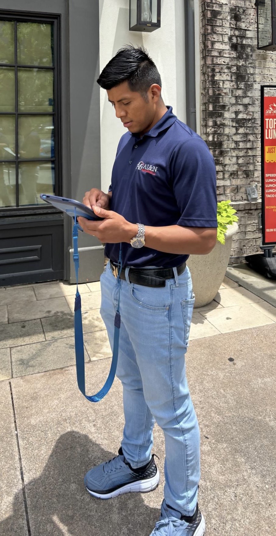 Arnulfo Lopez, founder of AL&N Painting Services, preparing an on-site estimate